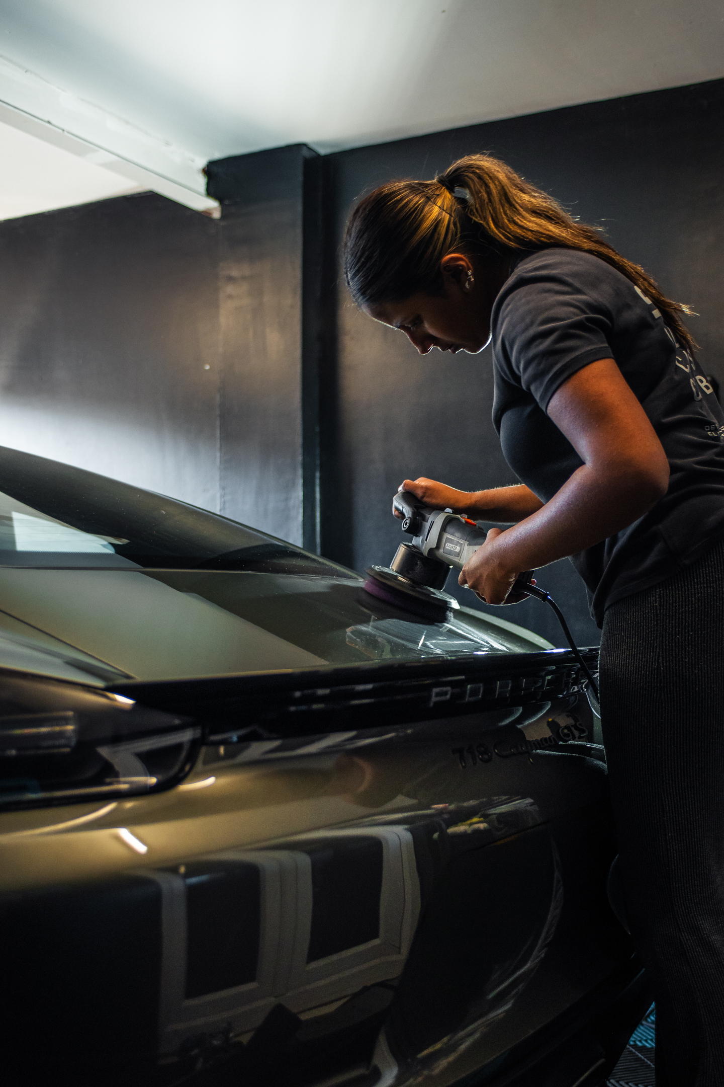S21 detailer machine polishing a Porsche panel